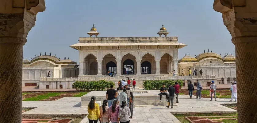 Local guide leading a small group on the Mughal Heritage Walk through a village near Agra