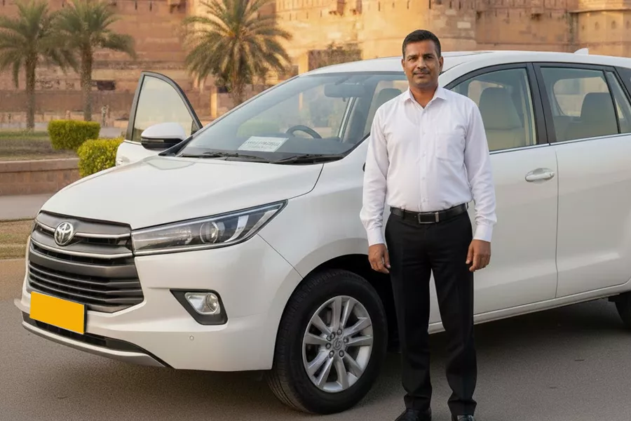 A family comfortably seated inside a spacious SUV, looking out at the scenic Rajasthan landscape during a drive